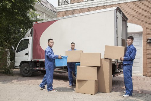 Professional house removalists in Uxbridge handling packed moving boxes