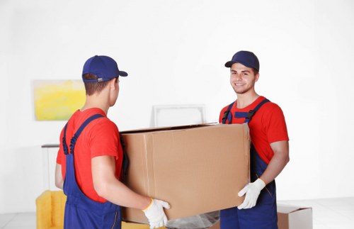 Removal team handling boxes during a house move in Uxbridge