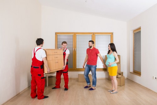 Professional movers using PPE and safe lifting methods in Uxbridge